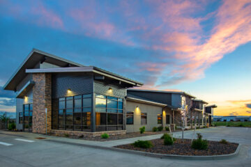 2534 Office Building front facade at dust against sky